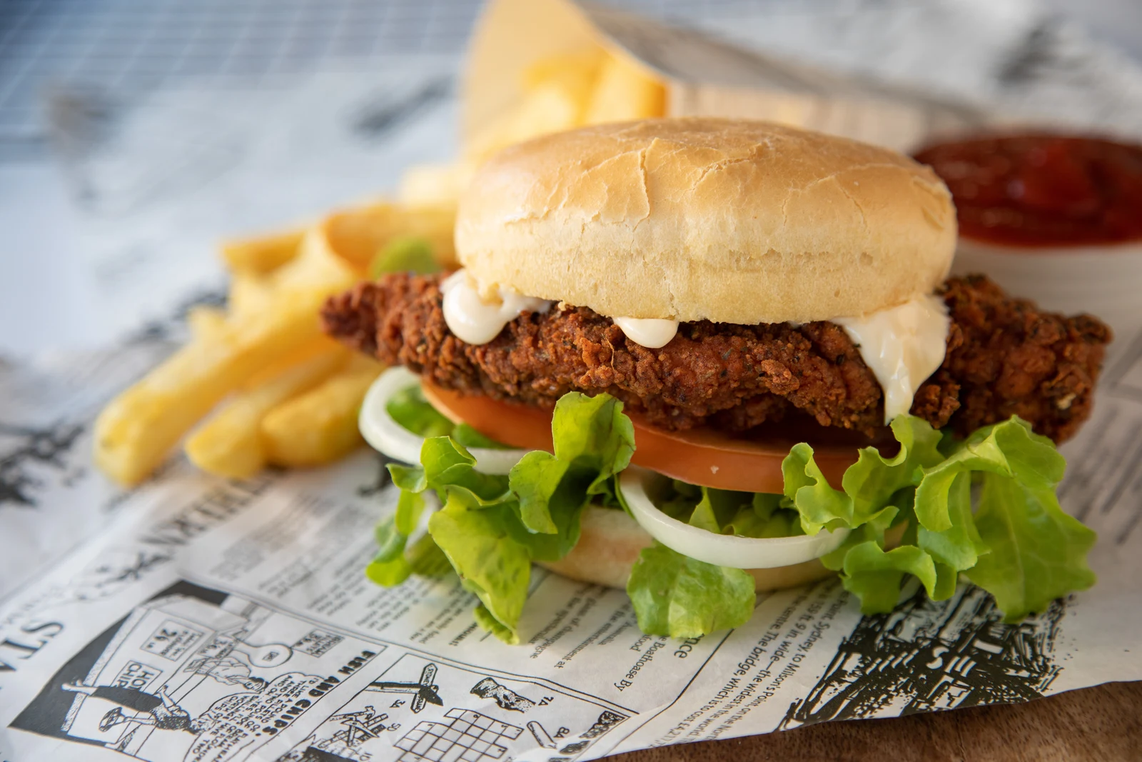 Crispy fried chicken burger with lettuce, tomato and fries